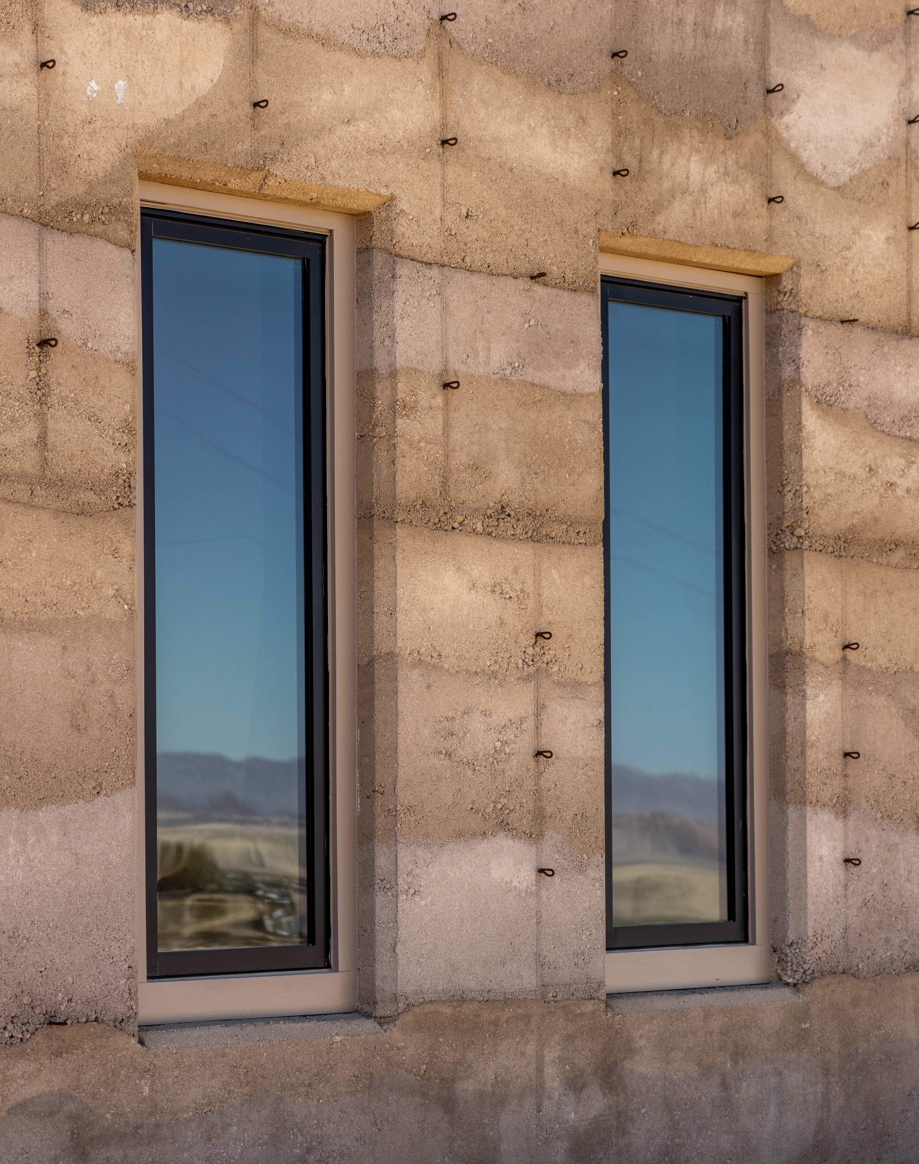 Two windows with a view of a mountainous landscape.