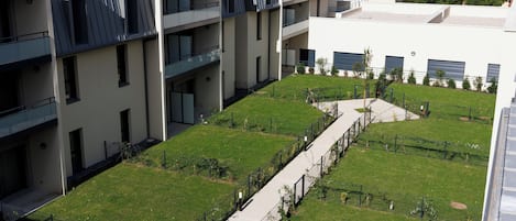 A multi-story building with a central courtyard, balconies, and a flat roof.