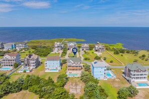A coastal residential area with multiple houses, a large body of water, and a golf course. - SemiSoundfront Dog Friendly w/ Pool, Elevator, Hot Tub, Tiki Bar, Cmty Boat Ramp (Salvo)