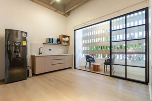 Fridge, microwave, coffee/tea maker, cookware/dishes/utensils
