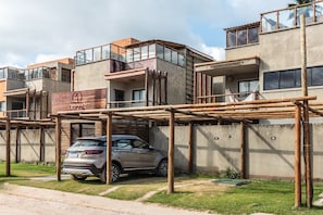 A multi-story building with a car parked in front.