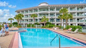 A swimming pool with lounge chairs and palm trees, surrounded by a multi-story building with balconies. - ☀️30A Private Beach Access-Pool-Inn at Seacrest 309- Somewhere in the Sun☀️ (Inlet Beach)