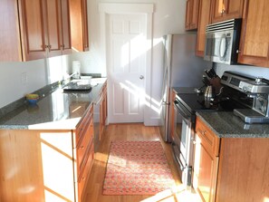 Fridge, microwave, oven, stovetop - Sunny and airy, one-level, one-bedroom condo in the heart of the West End. (Provincetown)