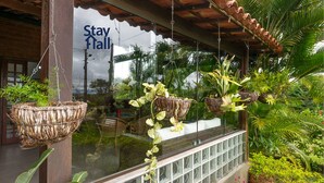 A hotel window with hanging planters and a 'Stay Hall' sign. - Casa de Campo Familiar em Gravata 065D (Gravata)