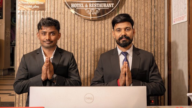 A reception desk at Sawamani Hotel & Restaurant with a check-out time sign and a Dell computer. - Hotel Sawamani and Restaurant (Danta Ramgarh)