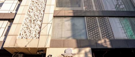 A hotel with a modern facade, featuring geometric patterns and a prominent entrance.