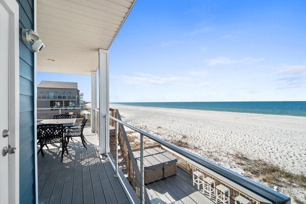 A wooden deck with outdoor furniture overlooking a beach. - Beachfront Duplex Unit, Pet Friendly, Mexico Beach, Gorgeous Views! (Mexico Beach)