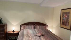 A bedroom with a large bed, a nightstand with a lamp, a dresser, and a framed picture on the wall. - Enjoy KRK waterfalls, sun, beach and sea: Domicile Sunce Kornati (Skradin)