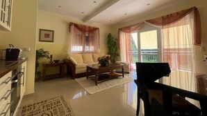 A spacious living room with a sofa, coffee table, and piano, featuring large windows and a balcony. - Enjoy KRK waterfalls, sun, beach and sea: Domicile Sunce Kornati (Skradin)