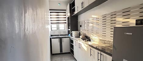 Mini-fridge, microwave, cookware/dishes/utensils