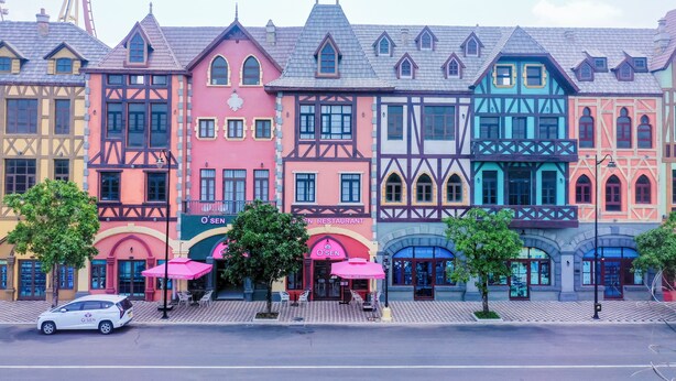 A row of colorful buildings with a restaurant named O'SEN. - Osen Hotel - Grand World Phu Quoc (Phu Quoc)