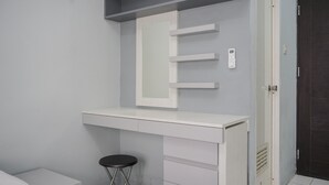 A small, modern room with a white desk, a stool, and a door. - Brand New And Super Cozy Studio Room At Sky View Apartment (South Tangerang)