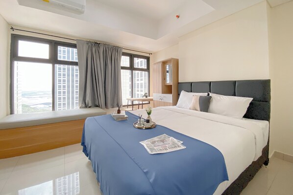 Relax in a spacious room with a large bed and city views from the window seat.