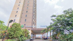 A tall hotel building with a sign reading "TAMANS PANORAMA". - Scenic View 2Br At Apartment Tamansari Panoramic (Bandung)