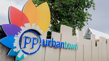 A sign with the text "PP Urbantown" and a colorful logo.