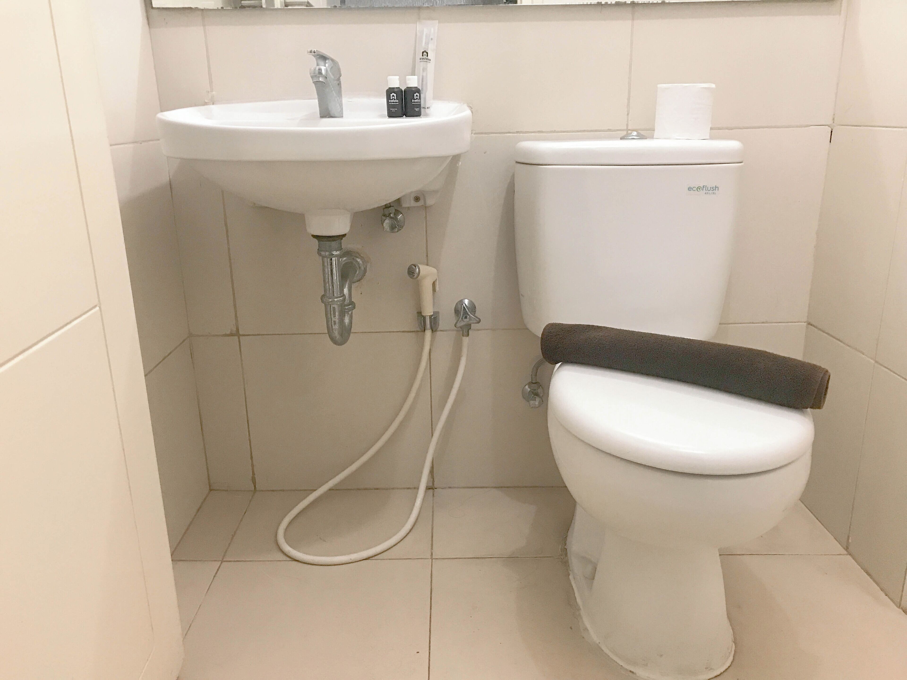 A bathroom with a white sink, toilet, and shower.