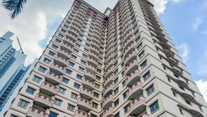 A high-rise building with multiple balconies and windows. - Spacious And Comfy 3Br At Puri Garden Apartment (Jakarta)