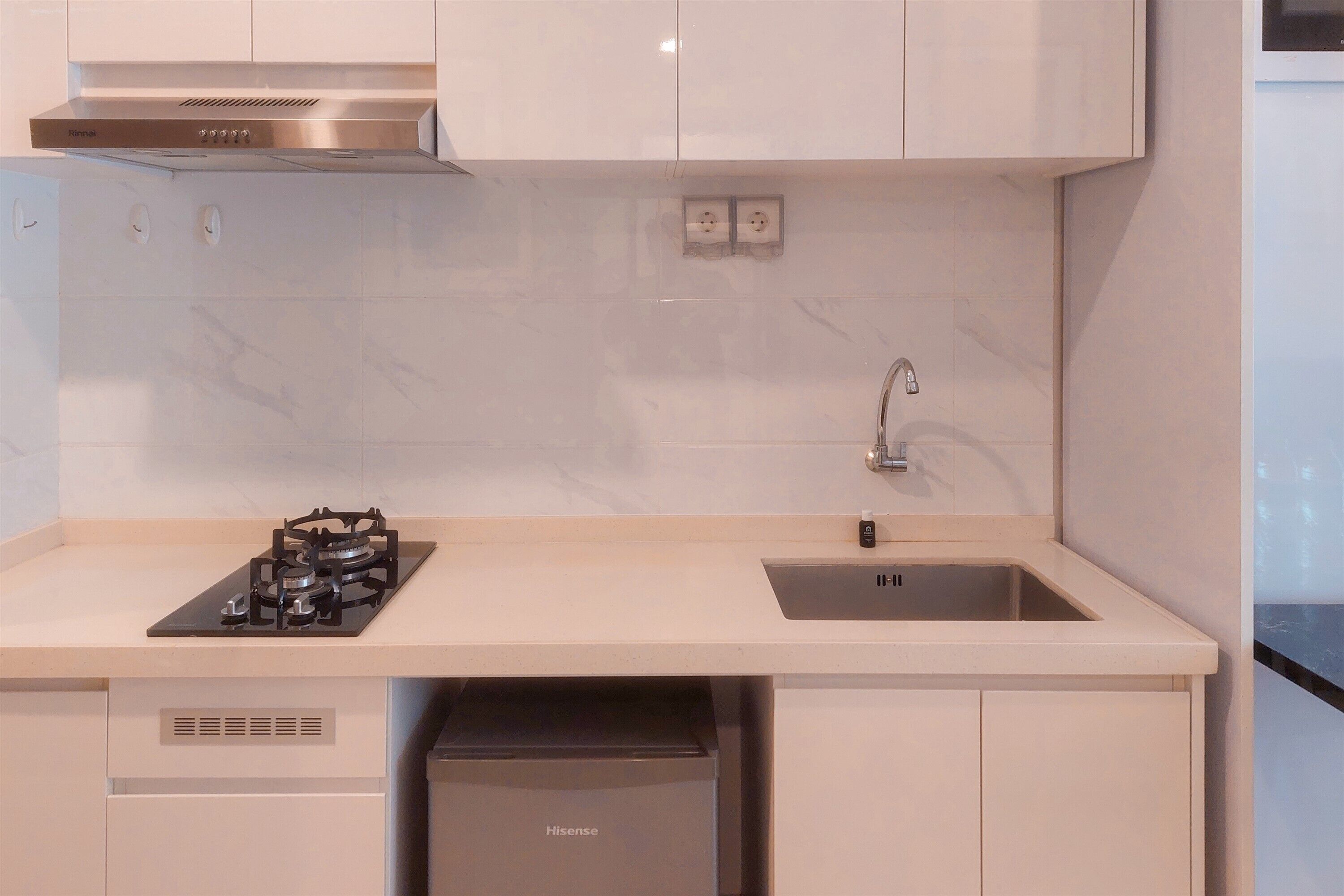 A modern kitchen with a built-in gas stove, a sink, and a dishwasher.