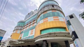 A modern building with a curved facade, large windows, and decorative metalwork. - Good Choice Studio Apartment At Sentraland Semarang (Semarang)