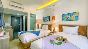 A hotel room with two beds, a desk, and a bathroom. - Comfortable Studio (No Kitchen) At Grand Palace Kemayoran Apartment (Jakarta)