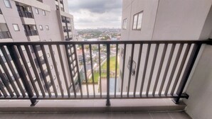 A balcony with a metal railing overlooking a cityscape. - Cozy And Simply 1Br Apartment Anwa Residence (South Tangerang)