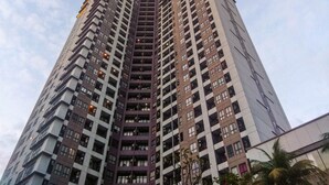A high-rise building with multiple floors, featuring a central core and a symmetrical facade. - Best Location And Strategic 2Br At Tamansari Semanggi Apartment (Jakarta)