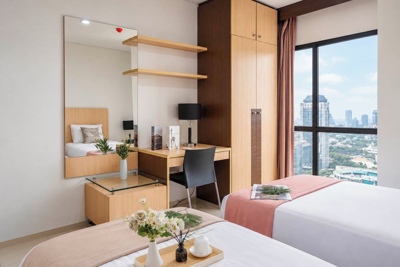 A hotel room with a bed, desk, chair, and a large window with a city view.