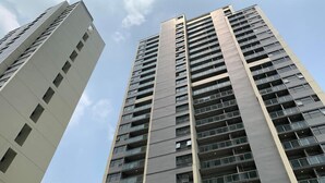 Two high-rise buildings with multiple floors and balconies, viewed from a low angle. - Modern And Comfy Studio At Daan Mogot City Apartment (Jakarta)