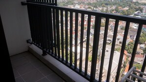 A balcony with a black railing overlooking a residential area. - Comfy Designed Studio Apartment At Anwa Residence (South Tangerang)