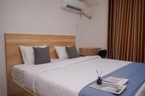Relax in this inviting room with a comfortable bed, bedside table, and chair.