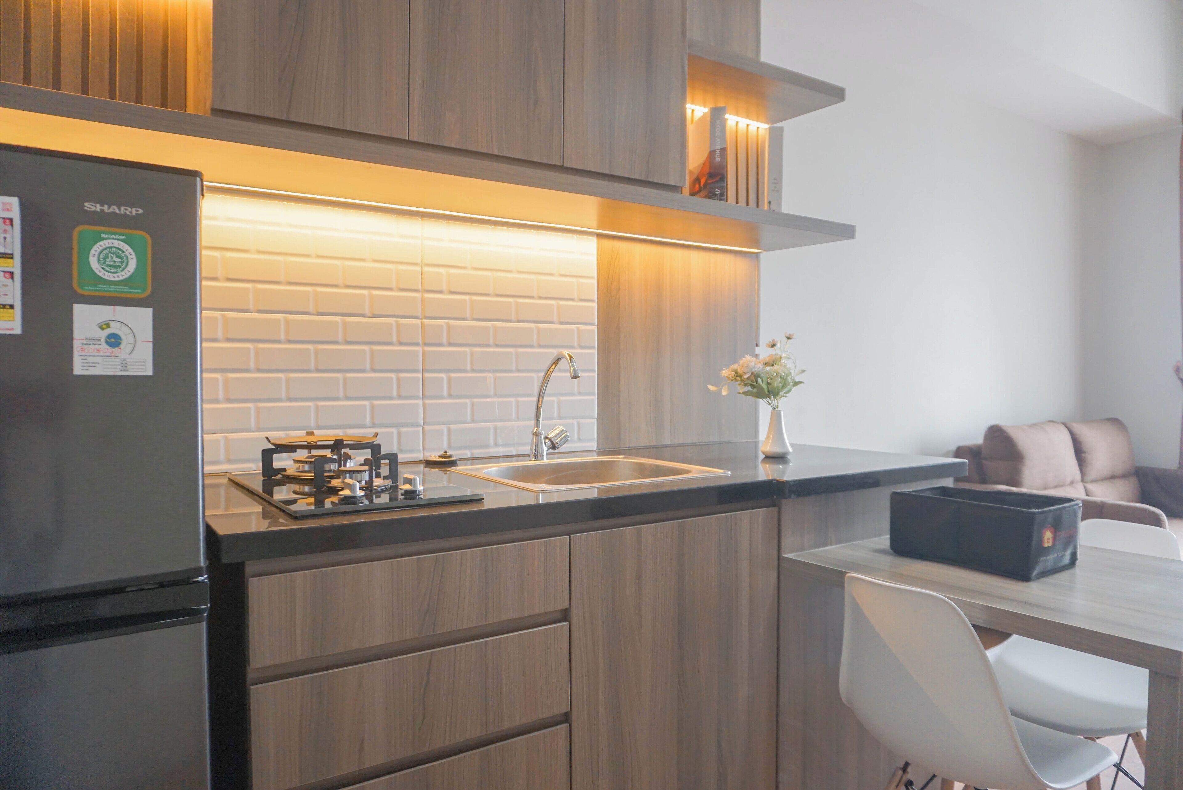 A modern kitchen with a built-in gas stove, a sink, and wooden cabinetry.