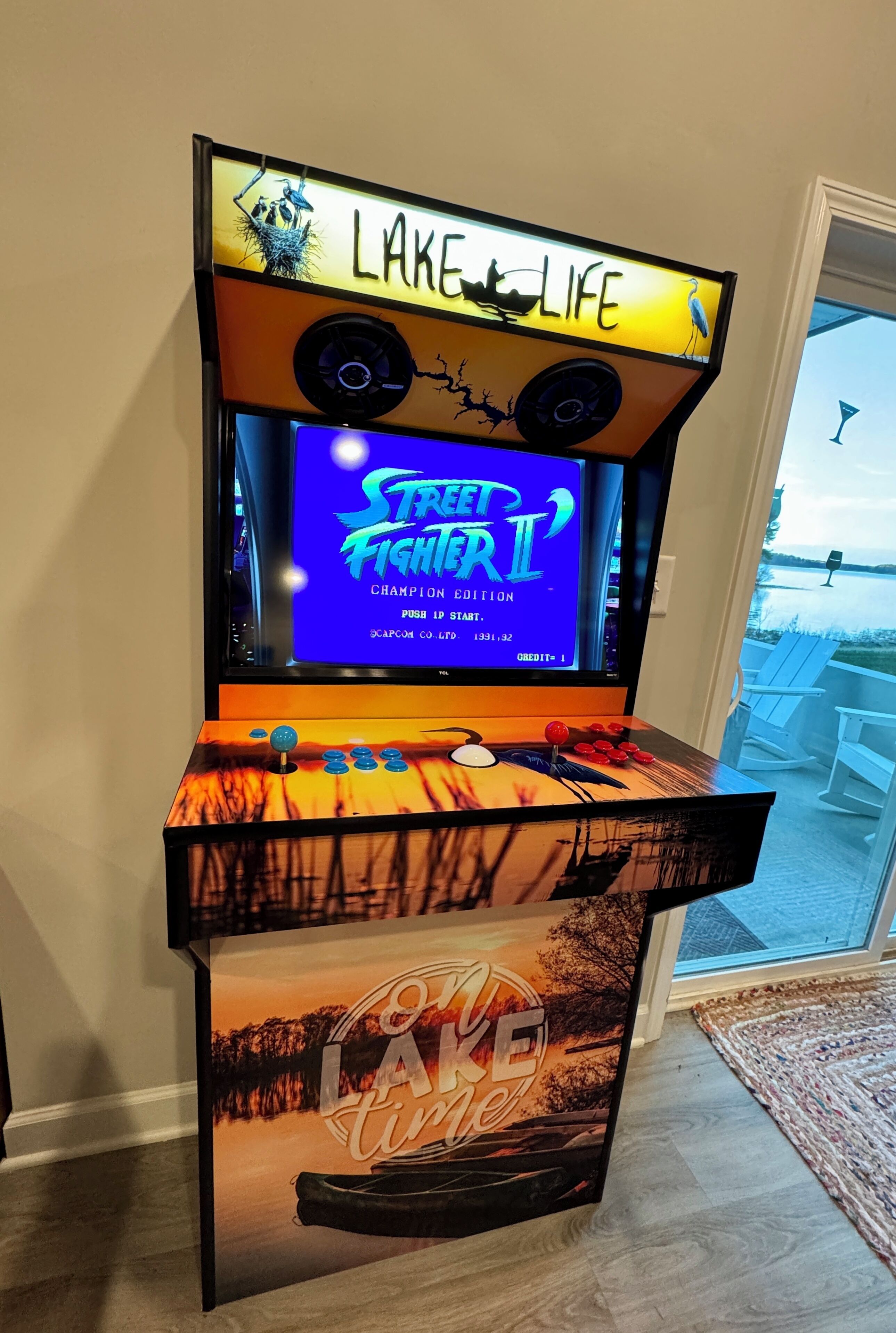 A video game arcade with a screen displaying 'Street Fighter II Champion Edition' and a sign reading 'Lake Life'.