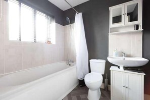 Separate bathtub and shower, deep-soaking bathtub, hair dryer, towels