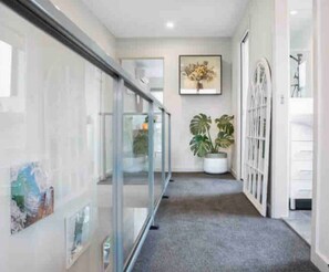 Stroll through this beautifully designed corridor, lined with potted plants and framed artwork.