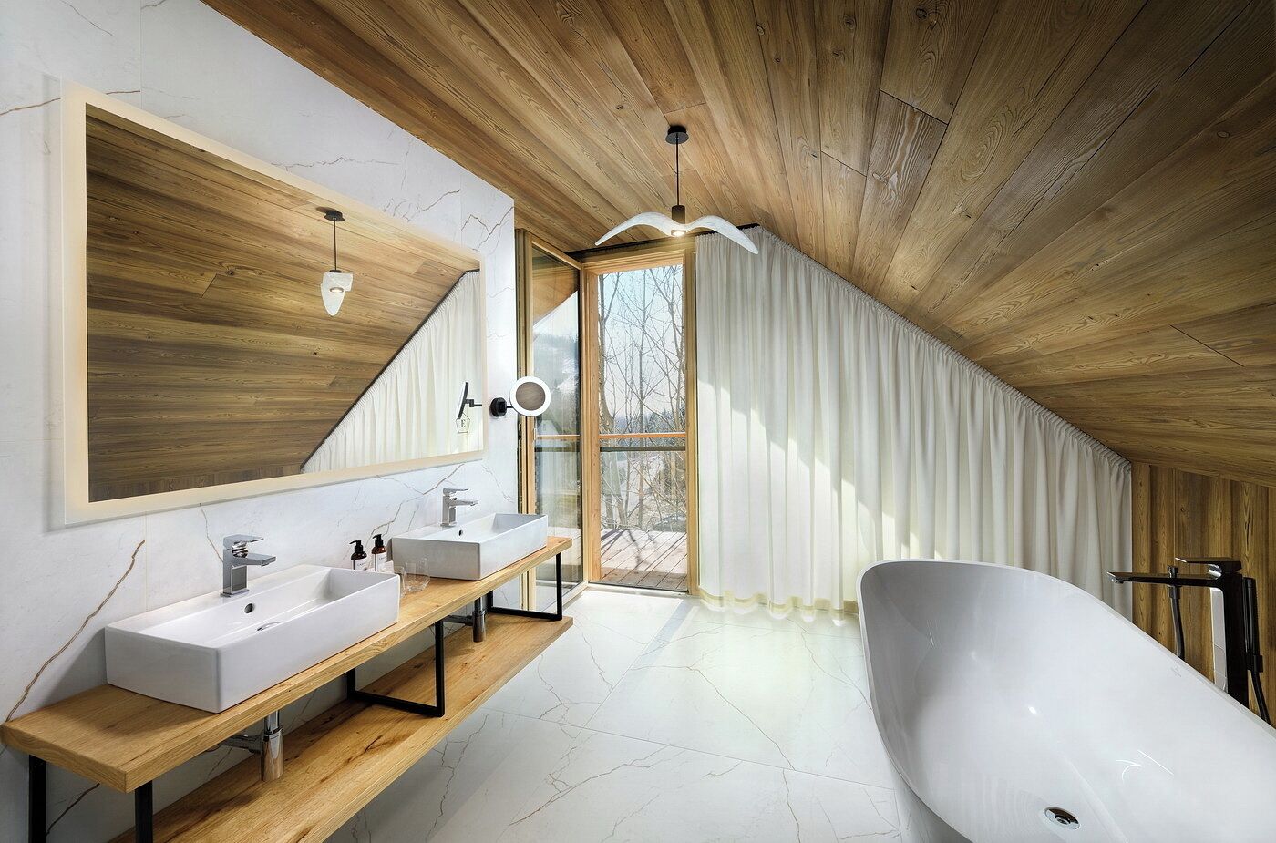A modern bathroom with a freestanding bathtub, a large mirror, and a wooden vanity.
