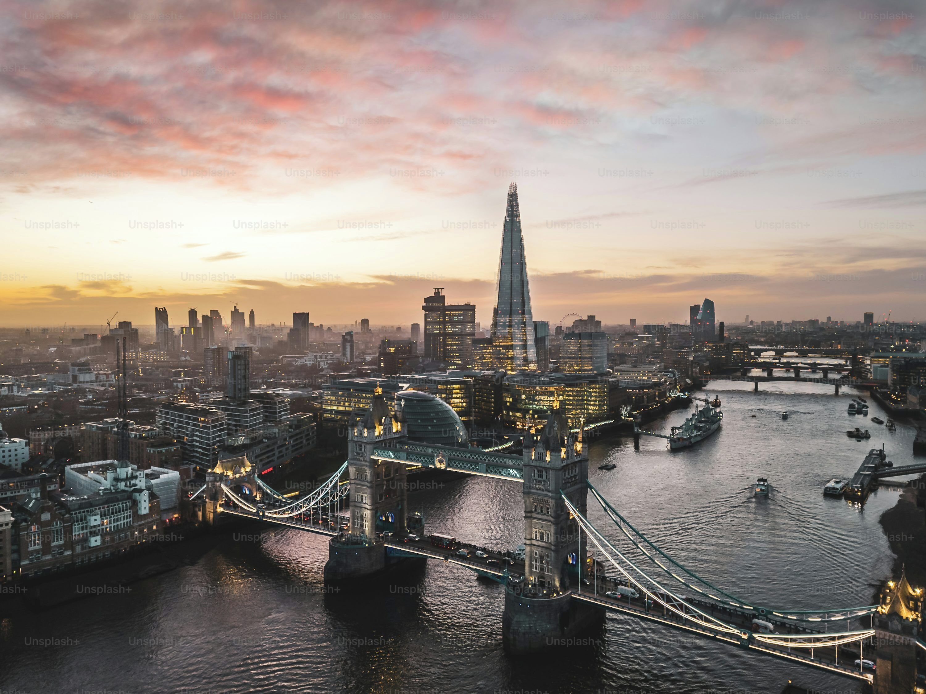 A cityscape with a prominent tower and a bridge over a river.