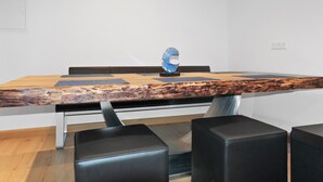 A conference table with a wooden top, black chairs, and a blue decorative piece.