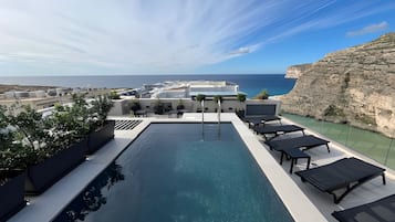 Seasonal outdoor pool, open 8:00 AM to 8:00 PM, pool umbrellas