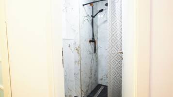 Shower, hair dryer, slippers, towels