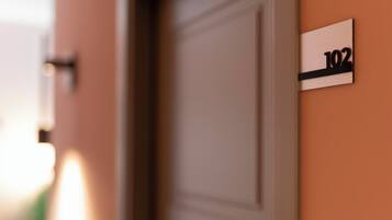 A close-up of a door with a sign indicating room number 102.