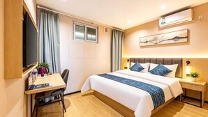 A hotel room with a bed, desk, chair, and a television. - GreenTree Inn Express Hotel (Beijing Fangshan District Government Longhu Tianjie) (Beijing)