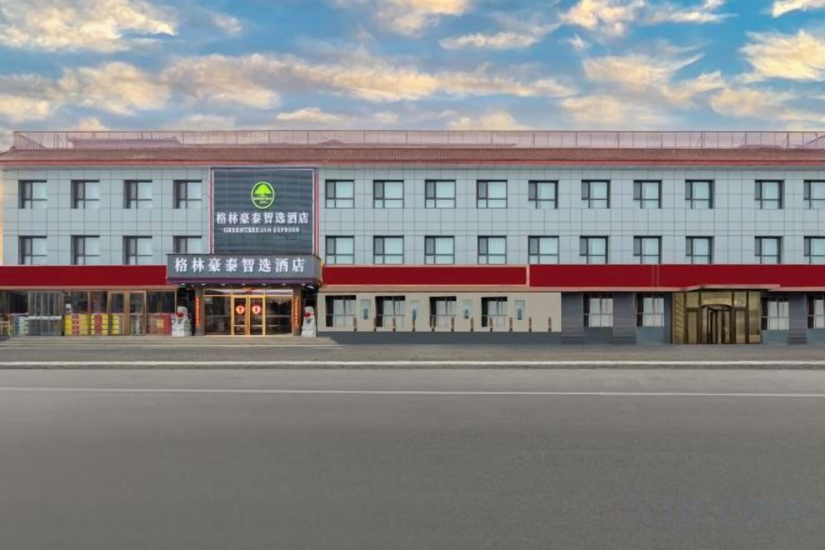 A hotel with a red and white facade, multiple windows, and a prominent entrance.