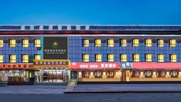 A multi-story hotel with a prominent sign in the center.