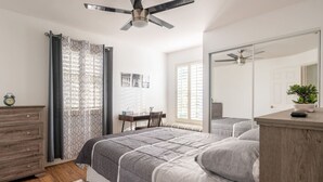 A bedroom with a bed, a dresser, a desk, and a chair. - Private Pool Home near 5th Ave, Old Naples and Beach (Naples)