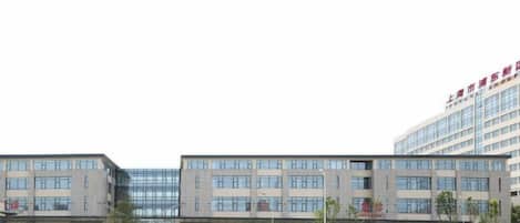 A multi-story building with a modern architectural style, featuring a large entrance and signage.