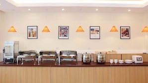 A hotel reception area with a counter, framed pictures, and orange pendant lights. - Homeinn Hotel (Shanghai Pudong Xinchang Industrial Park Tanzhi Town) (Shanghai)
