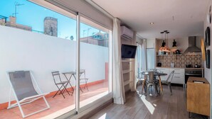 A modern apartment with a balcony, a dining area, and a kitchen. - Jaume Atico 509 - Studio Apartment, Sleeps 2 (Barcelona)