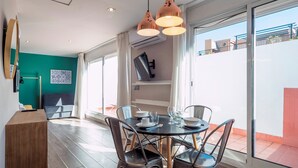 A modern dining area with a round table, chairs, and pendant lighting. - Jaume Atico 509 - Studio Apartment, Sleeps 2 (Barcelona)