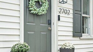 A front door with a wreath, a mailbox, and a welcome mat. - Copper Hill Home in Walnut Creek (Sugarcreek)