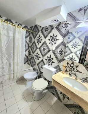 Bidet, towels, soap, toilet paper